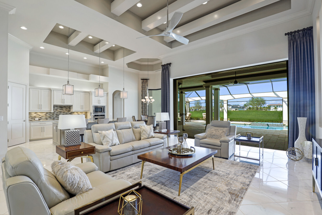 The expansive Living Area with 16′ Ceilings is an Entertainers Delight, opening to the Pool Deck with pocketed sliding doors. | 16459 Seneca Way – Naples, Florida 34110 - Listed By Janine Monfort - Naples, Florida Real Estate Agent at Premier Sotheby's International Realty
