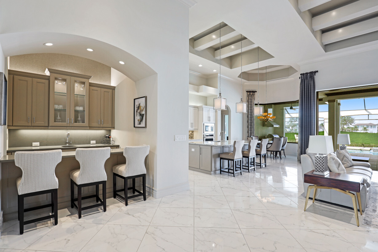 Wet Bar with Wine Cooler & Drink Fridge, five total seating areas! | 16459 Seneca Way – Naples, Florida 34110 - Listed By Janine Monfort - Naples, Florida Real Estate Agent at Premier Sotheby's International Realty