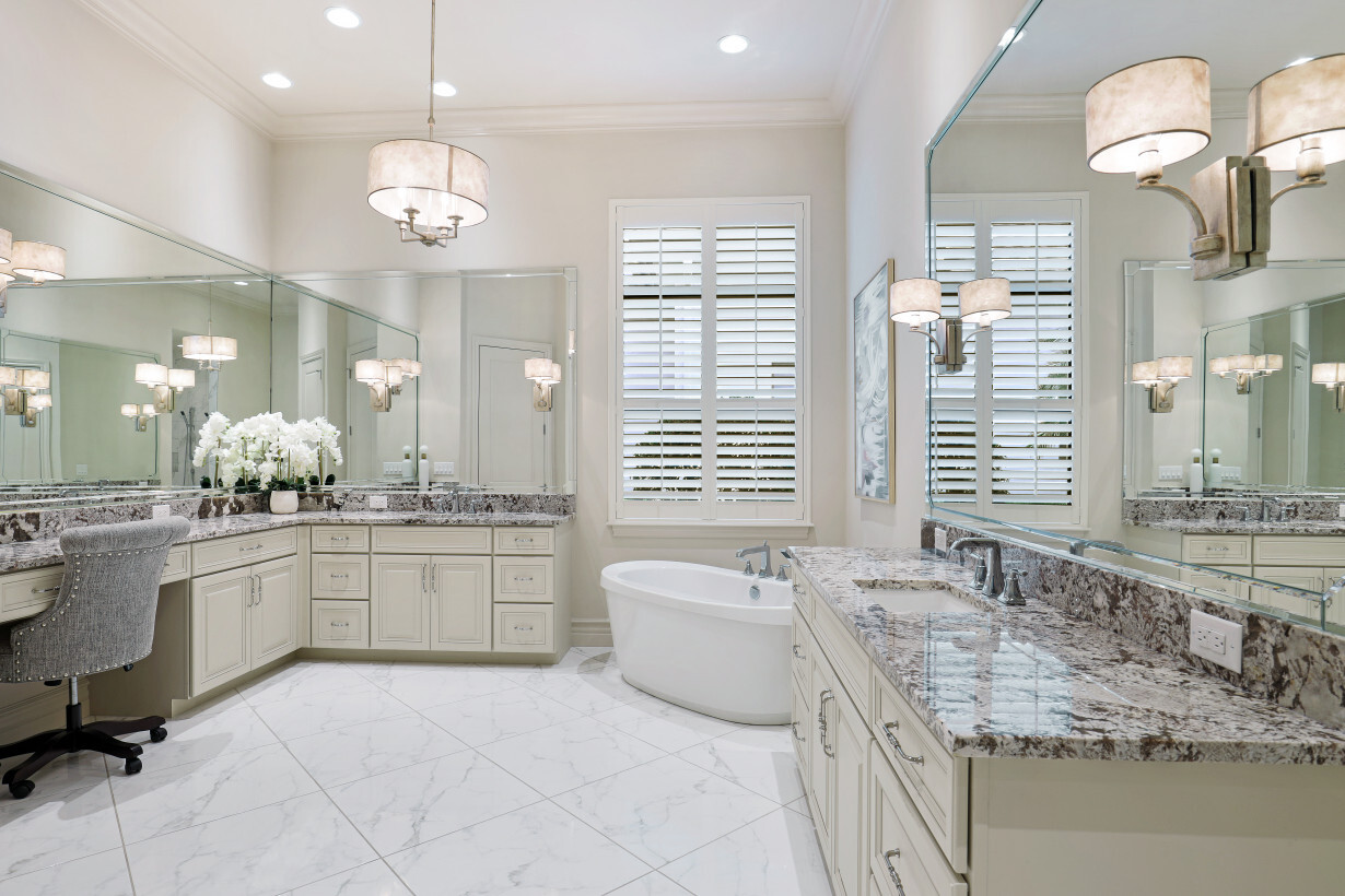 Master Bath with beautiful natural light features a vanity, soaking tub and multiple head shower heads | 16459 Seneca Way – Naples, Florida 34110 - Listed By Janine Monfort - Naples, Florida Real Estate Agent at Premier Sotheby's International Realty